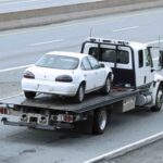 Quck Fast Tow truck towing a broken car in San Antonio